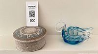 Overall lot showing glass swan and lidded stoneware dish with scale card
