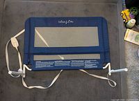 Front view of blue Dream On Me mesh bed rail with straps and hardware visible