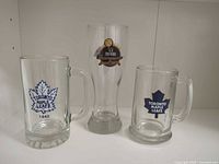 Front view of all three glasses showing logos and shapes