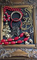All jewelry pieces arranged within ornate frame