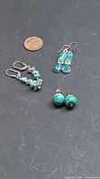 All three earring pairs beside penny for scale