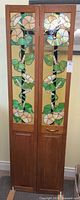 Full front view of two-panel stained glass divider standing upright