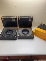 Two open Kodak boxes each showing a slide tray and a closed tray box