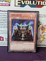 Front of Lord of D. card in sleeve showing artwork, name, level, attribute, stats and first edition marking