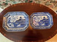 Both Burleigh Ware Old Willow platters top view showing pattern and size difference
