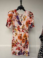 Front view of floral H&M dress on hanger