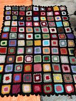 Full view of the multicolor granny square afghan laid flat