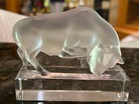 Left front view of frosted crystal bull on clear base
