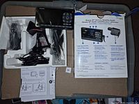 Receiver and accessories in foam tray alongside torn box lid