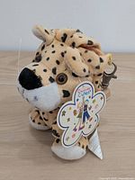 front three-quarter view showing plush on tag and clip