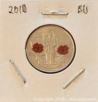 Coin in 2×2 holder showing reverse soldier and colour poppies