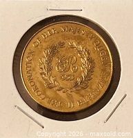 Reverse of brass coronation medallion showing wreath, ER monogram and inscription