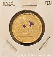 Reverse of 2022 Oscar Peterson commemorative loonie in flip