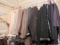 Full rod view of assorted medium women’s coats, jackets, shirts and sweaters