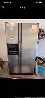 Front view of Kenmore stainless steel side-by-side refrigerator with dispenser