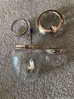 two cut glass dresser jars with sterling rims, loose sterling rim, spoon visible