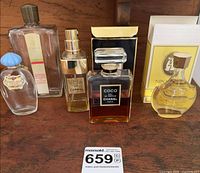 Group shot of five perfume bottles and packaging