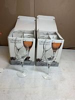 Two open boxes showing four compartments each and loose glasses in front