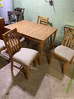 table and four oak chairs overall view