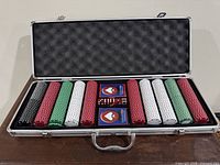 Open aluminum case showing chips, cards and dice