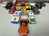 Front view of 15 die-cast cars lined up