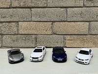 Front view of all four die-cast cars lined up