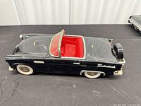 Left front side view showing body color, interior, wheels, and Thunderbird script
