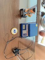 Overall lot showing scale, adapter, figurine, and coin