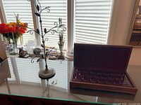 Coin box and earring stand on tabletop