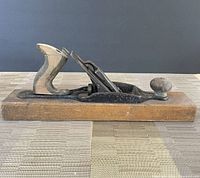 Left side view of Stanley No.27 wood-bottom plane showing complete form