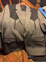 Front view of gray western jacket with black yoke and flap pockets
