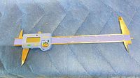 Full view of digital caliper showing jaws, beam, and electronics