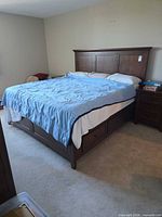 Full view of king bed, linens, matching nightstand