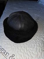 Black sheepskin ushanka hat side view