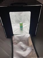 Assembled Glendan light box with interior lit and sample object for scale