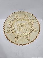 Top view showing fruit motif and star pattern of amber glass tray