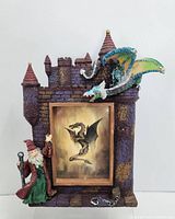 Full view of resin castle picture frame with wizard and dragon detailing