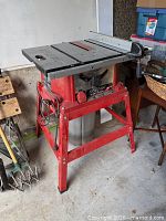 Front view of SKILSAW table saw on red stand with attached rip fence