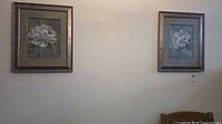 Both framed floral prints on wall