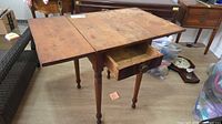 Table with both leaves up and drawer open showing interior