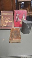 Three books displayed: pocket prayer book, Poems of Robert Burns, Tales