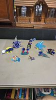 Group shot of all ten glass figurines on tabletop