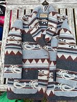 Front of patterned wool-blend coat showing collar, buttons and pockets
