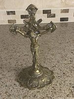Front view of brass crucifix on stand