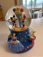 Front view showing Mickey, Minnie inside globe and Cinderella, Tinker Bell on base