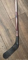 Full view of hockey stick showing blade and shaft graphics