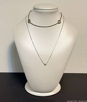 Both jewellery pieces displayed on bust form