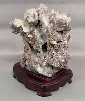 Front view of fluorite-quartz cluster on wooden base
