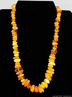 Front view of full necklace on black display bust