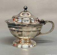 Sterling silver mustard pot front view showing pedestal base, handle and lid